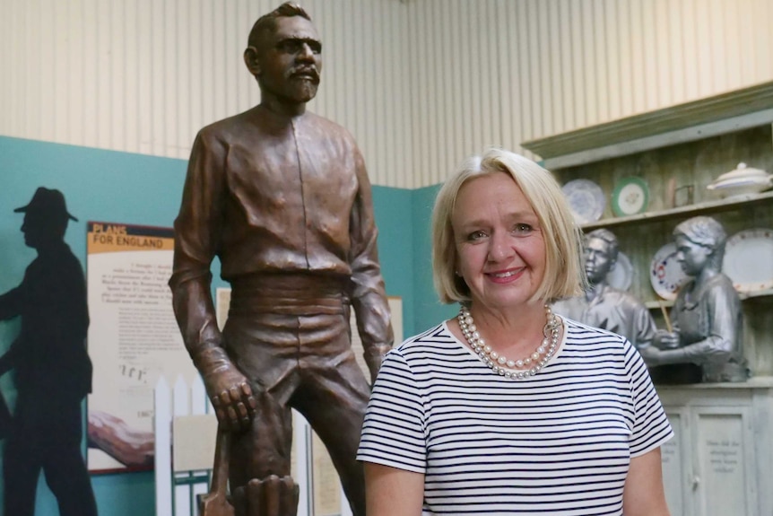 Harrow Discovery Centre manager Josie Sangster in front of a statue of Johnny Mullagh.