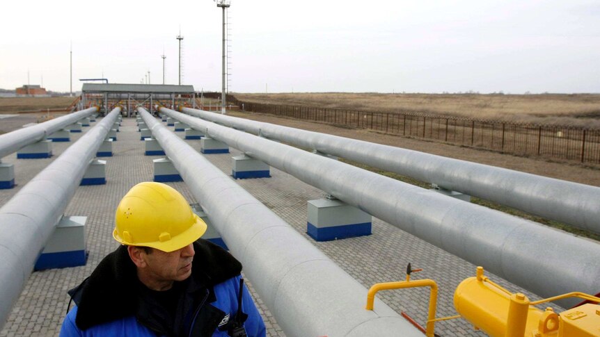 A Gazprom worker walks next to pipelines at a gas measuring station at the Russian-Ukrainian border.