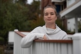 A female standing on the porch.