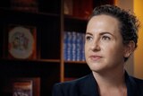 A close up of Lia Finocchiaro sitting in her parliamentary office.