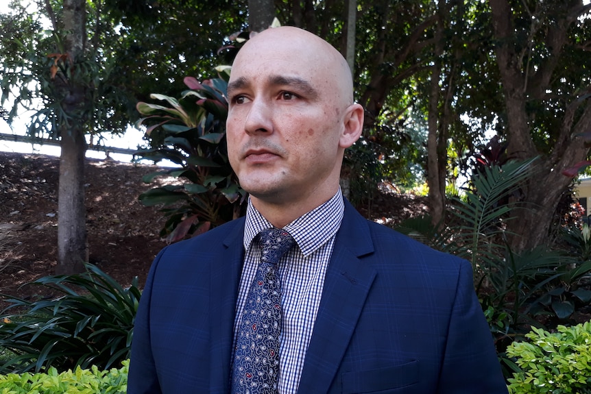 a man wearing a blue suit and tie