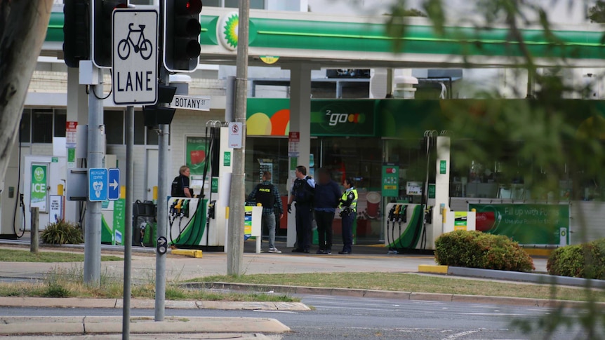 Police arrest a man at a Phillip BP petrol station