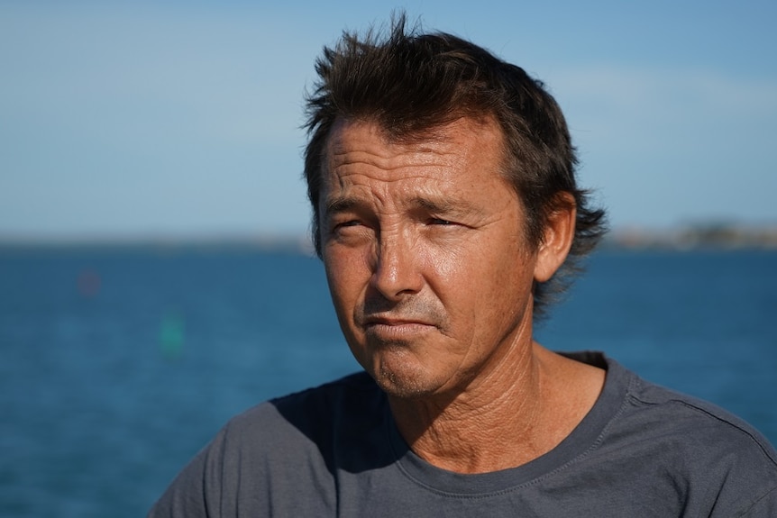 A head shot of Craig Van Lawick with the ocean behind him