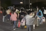 A group of workers leave the factory site in China.