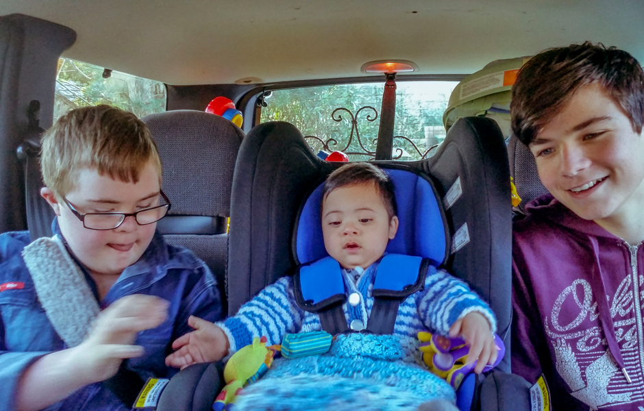 Adopted toddler Daniel on the way home with his new brothers after leaving foster care.