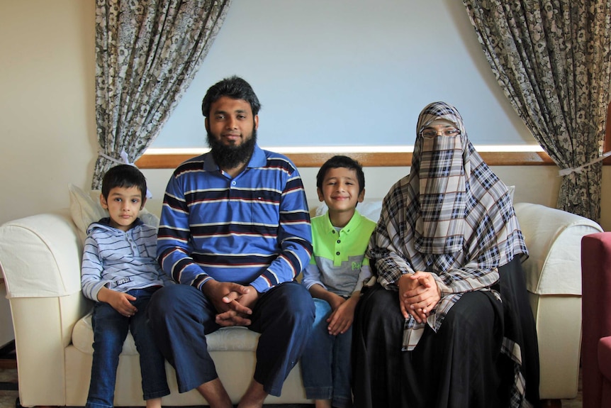 A family sitting on the couch