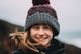 Girl in beanie being blasted by wind