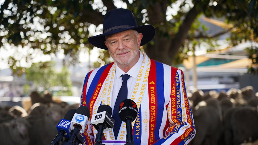 Murray Wilton in a black hat and striped blue, red and white jacket