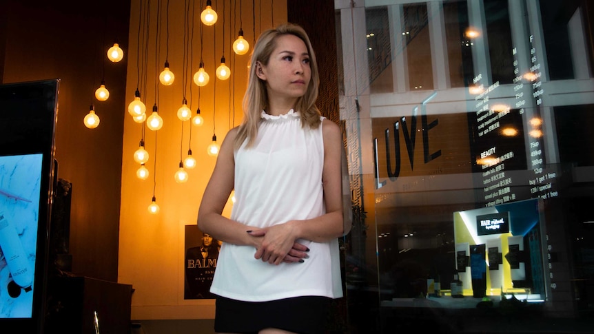 Roni Law stands inside her hair salon in Sydney.