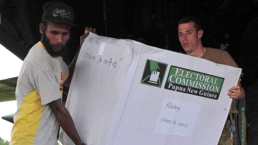 Australian soldier helps unload ballot boxes