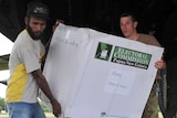 Australian soldier Ben Crawford helps a member of the PNG Election Office in 2012.