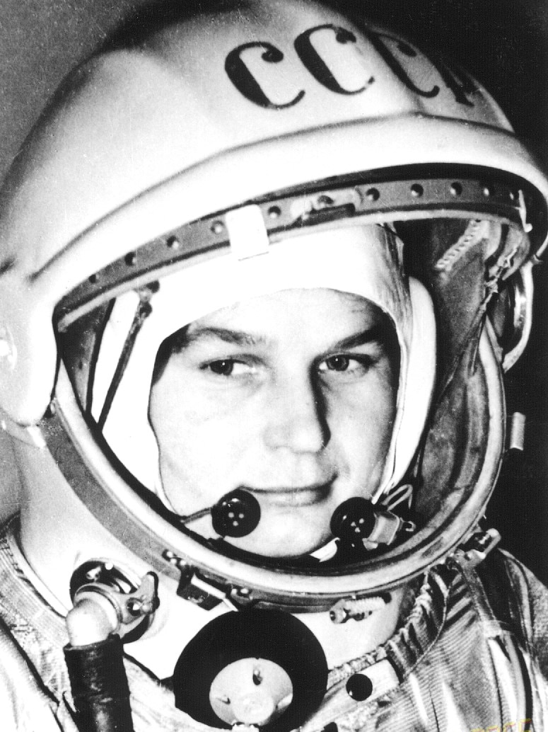 A black and white photo of a woman in a space helmet