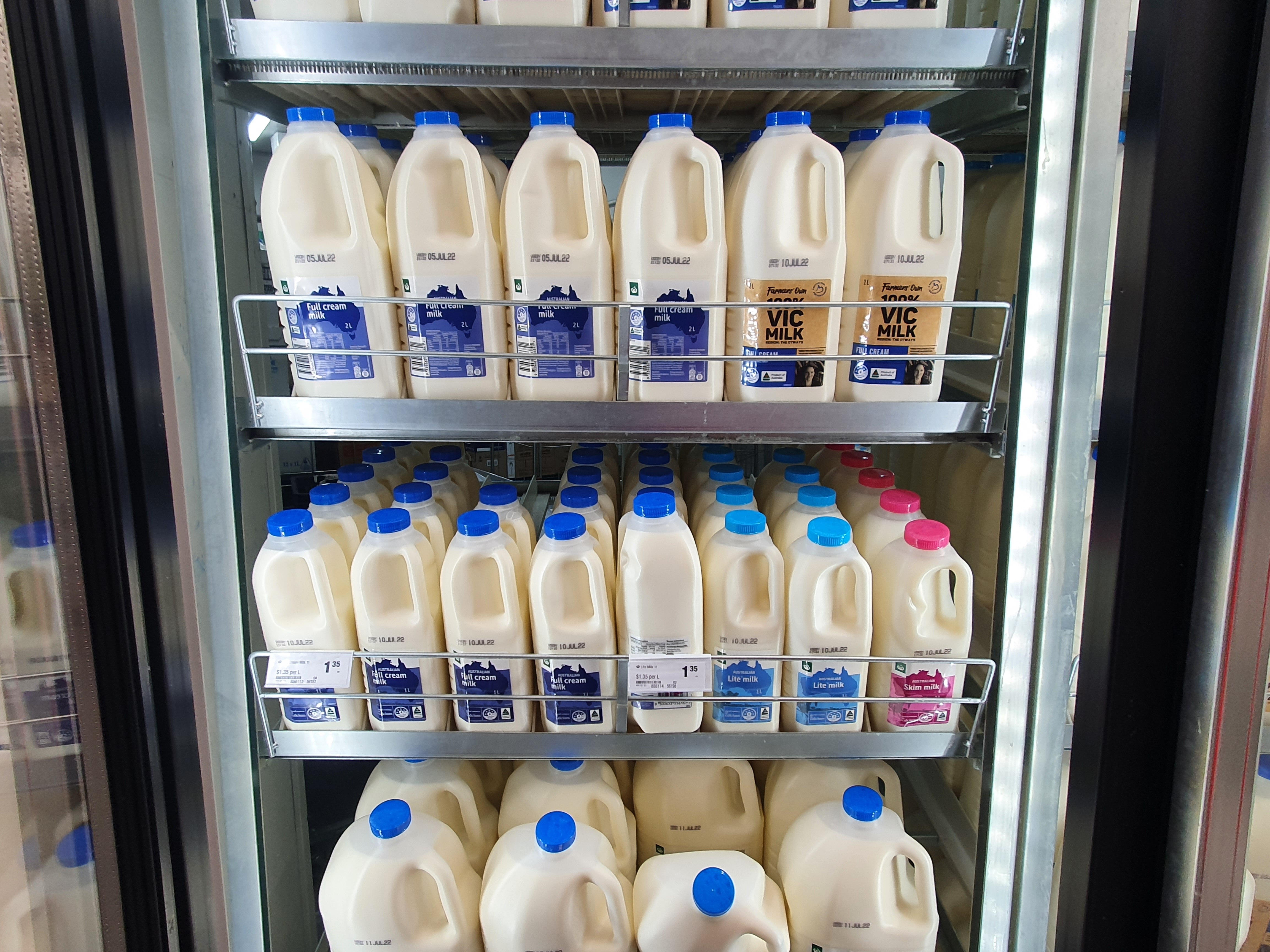 Supermarket shelf of discounted milk.