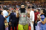 Indian spiritual guru who calls himself Saint Dr Gurmeet Ram Rahim Singh Ji Insan greets followers on the red carpet.