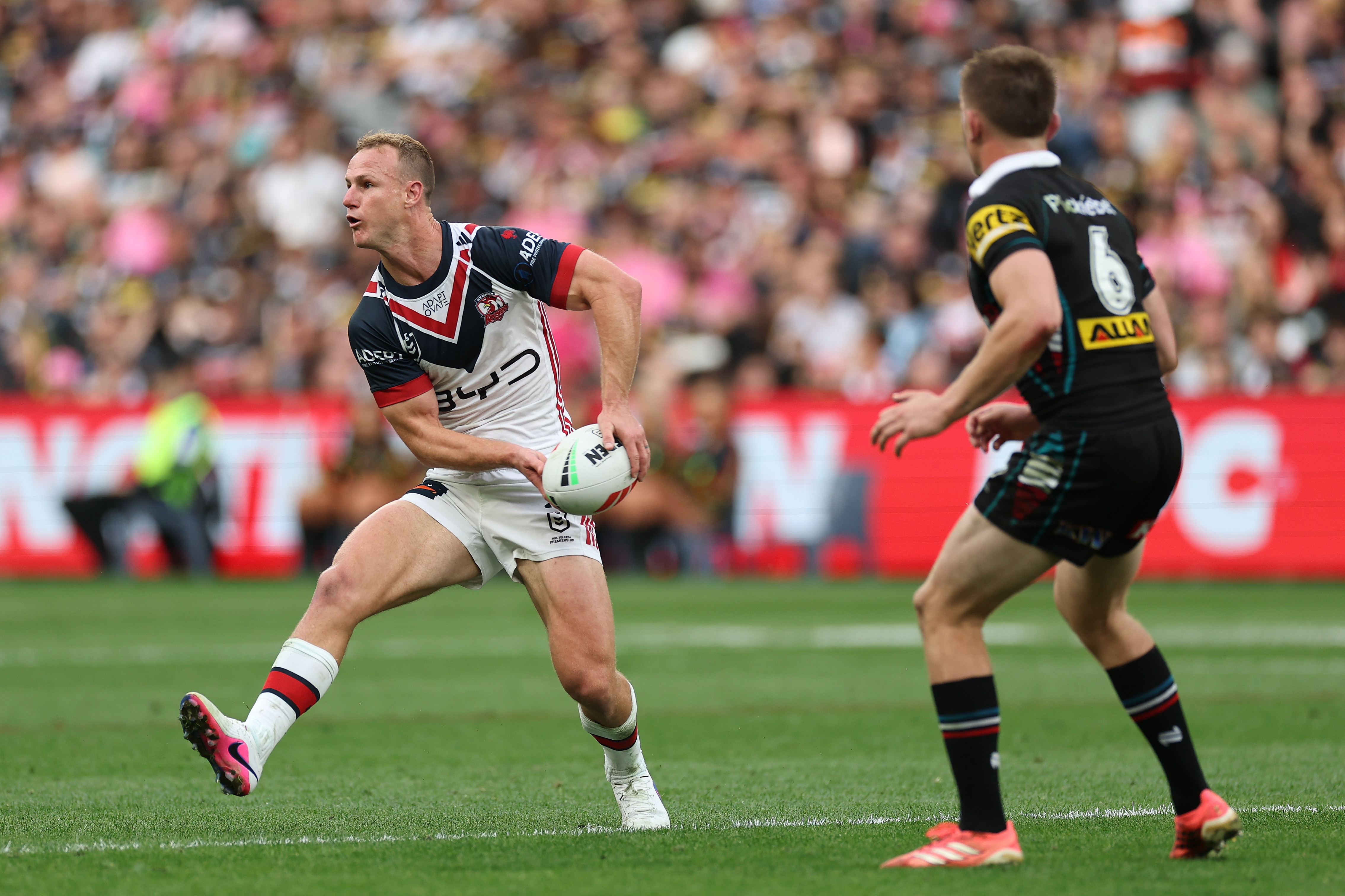 A man runs the ball during a rugby league match