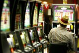 A late-night gambler plays the pokies