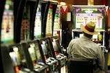 A late-night gambler plays the pokies