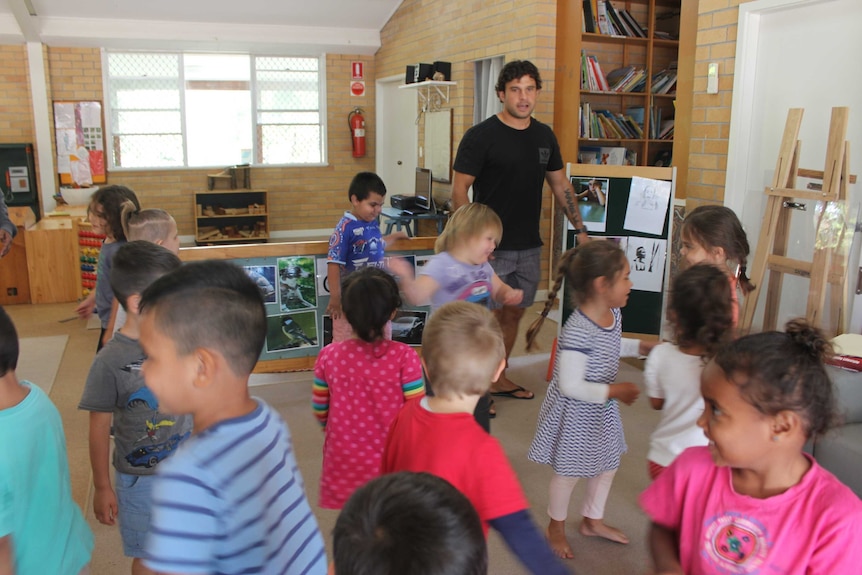 Indigenous educator Clarke Webb teaching language to pre school kids.