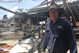 Carl Walker in his packing shed, which was ripped apart in the cyclone.
