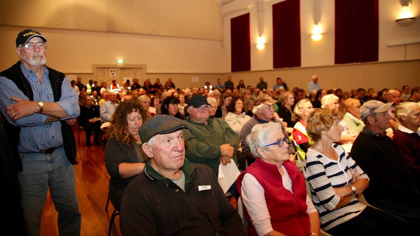 Hundreds of Terang locals in a local hall at a community meeting.