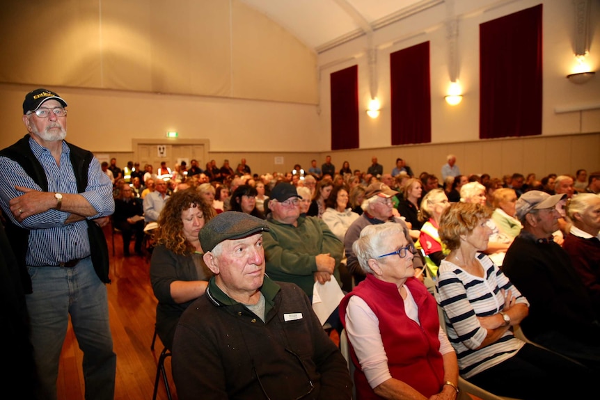 Hundreds of Terang locals in a local hall at a community meeting.