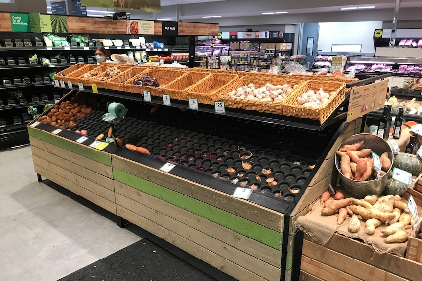 Empty fruit and vegetable shelves 