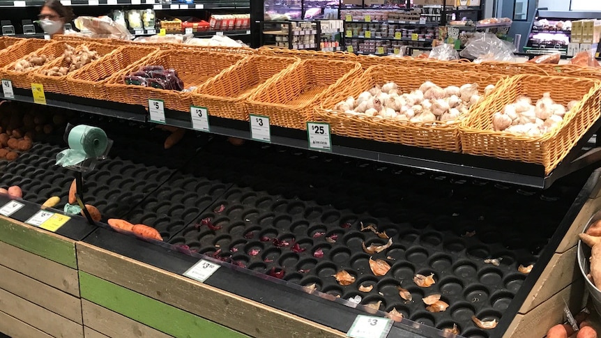 Empty fruit and vegetable shelves 