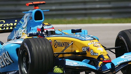 Fernando Alonso acknowledges the crowd after securing pole