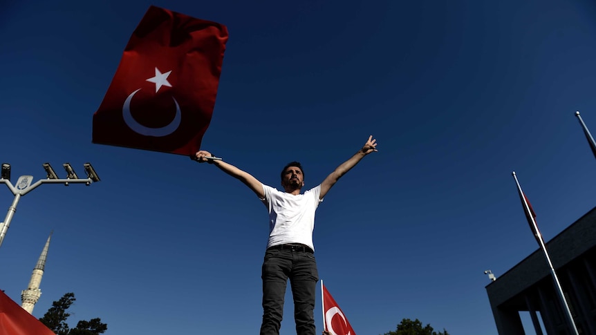 A man waves a Turkish flag in Istanbul