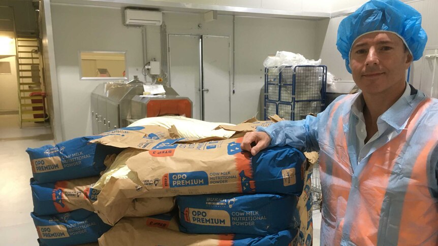ViPlus Dairy sales and marketing manager Chris McKiernan with bags of powdered milk.