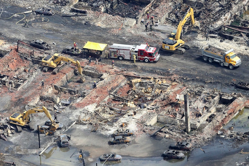 Workers and firefighters work in Lac Megantic after train explosion.