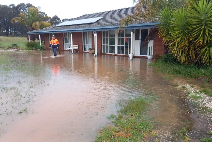 house with floodwater lapping at door