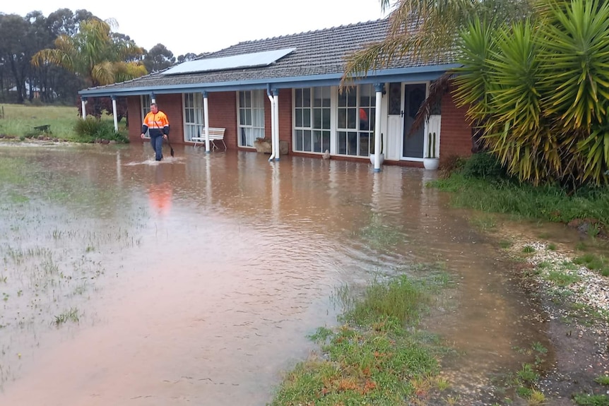 house with floodwater lapping at door
