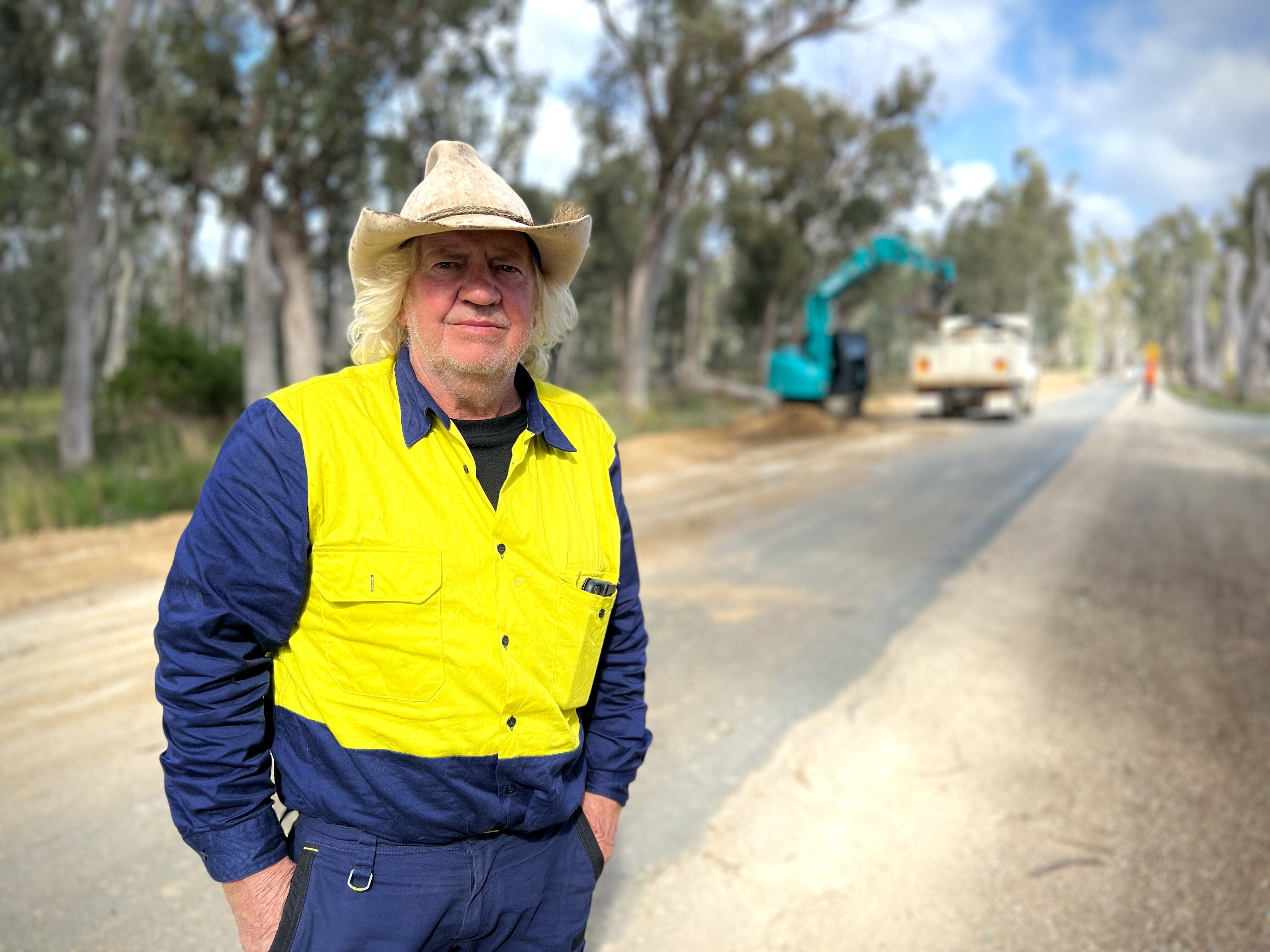Man standing in front of flood levee