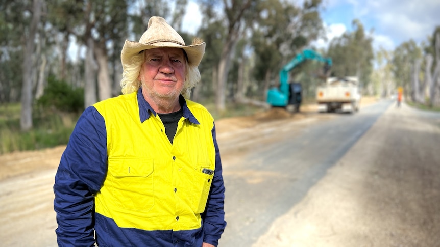 Man standing in front of flood levee