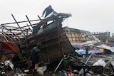 A man on top of his damaged house in Tacloban