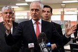 A mid shot of Prime Minister Malcolm Turnbull with Ministers Ken Wyatt and Simon Birmingham by his side at a media conference.