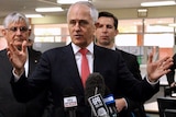 A mid shot of Prime Minister Malcolm Turnbull with Ministers Ken Wyatt and Simon Birmingham by his side at a media conference.