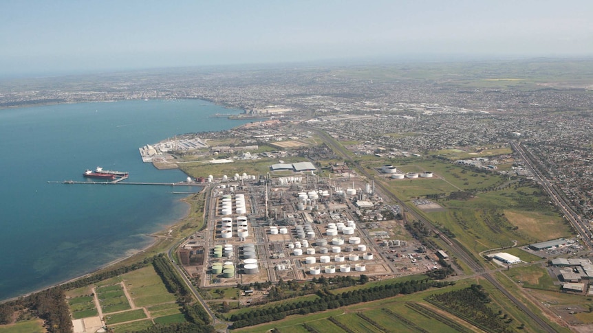 an aerial view of an oil refinery on the coast