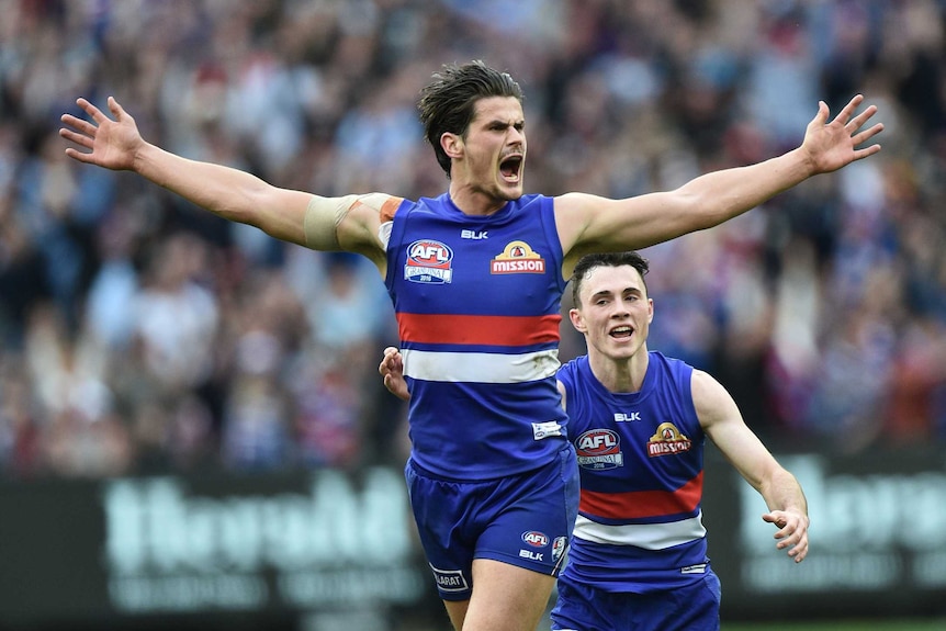 Tom Boyd celebrates kicking a goal for the Bulldogs in their 2016 grand final win.