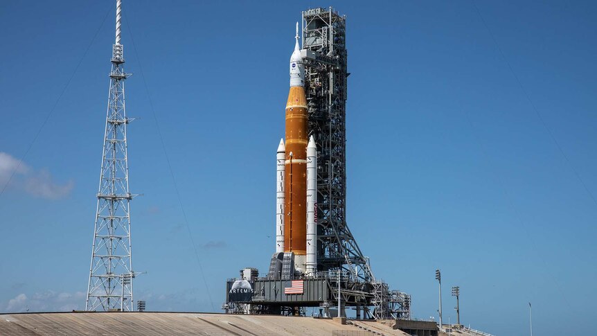 A space rocket on a launch pad on a bright clear day.
