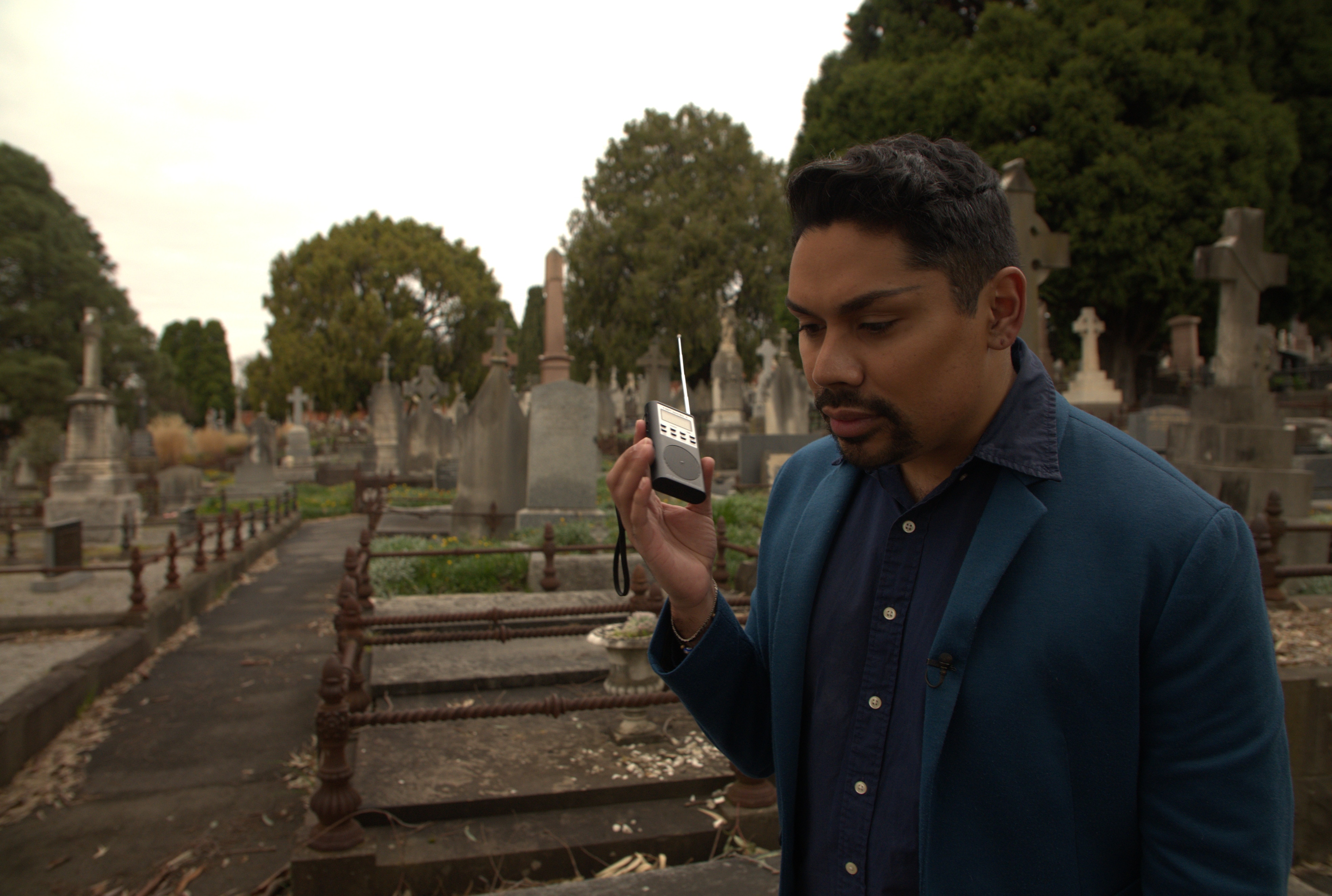 Cael O'Donnell stands in a graveyard