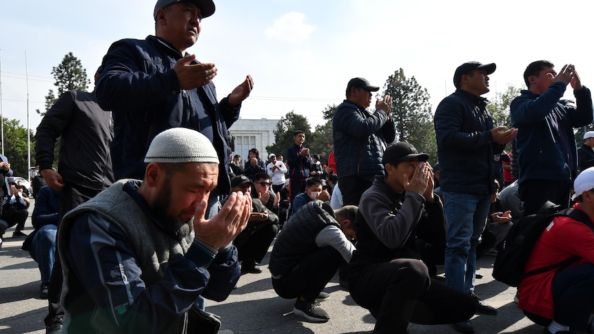 People praying while kneeling