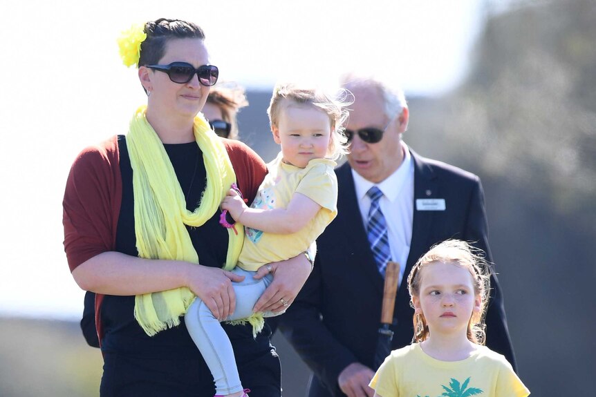 Briony Lyle and daughters Lusi and Jemma at a public memorial service for golfer Jarrod Lyle.