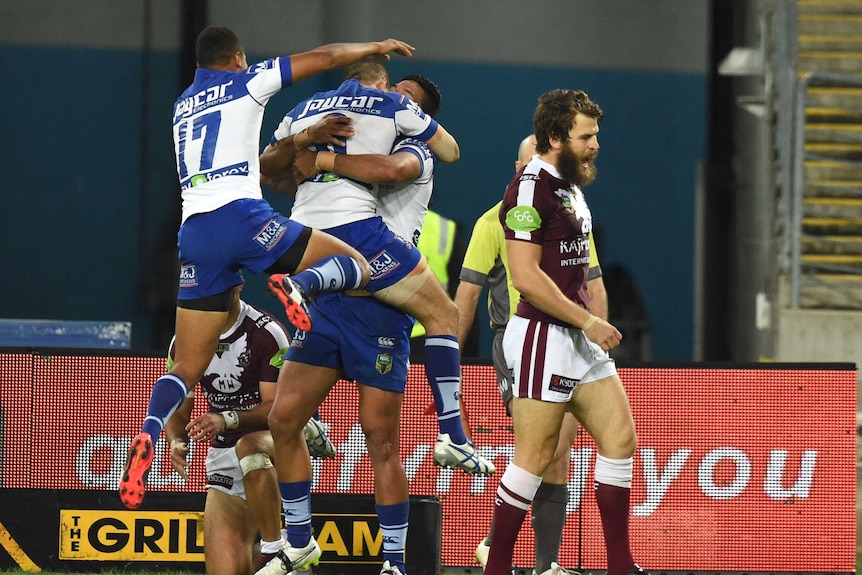 Bulldogs celebrate in front of Manly's David Williams