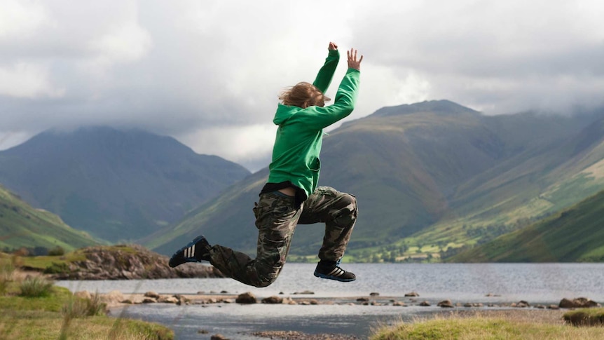 A teenager jumps across a gap at Scafell Pike, in the UK's Lake District.