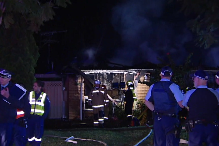 Police and firefighters at a house fire