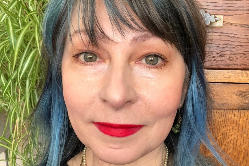 Meredith Jones with blue hair and red lipstick