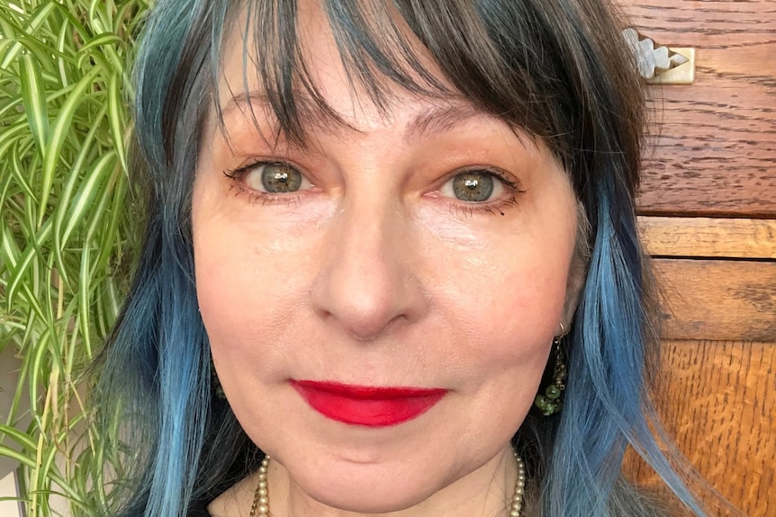 Meredith Jones with blue hair and red lipstick