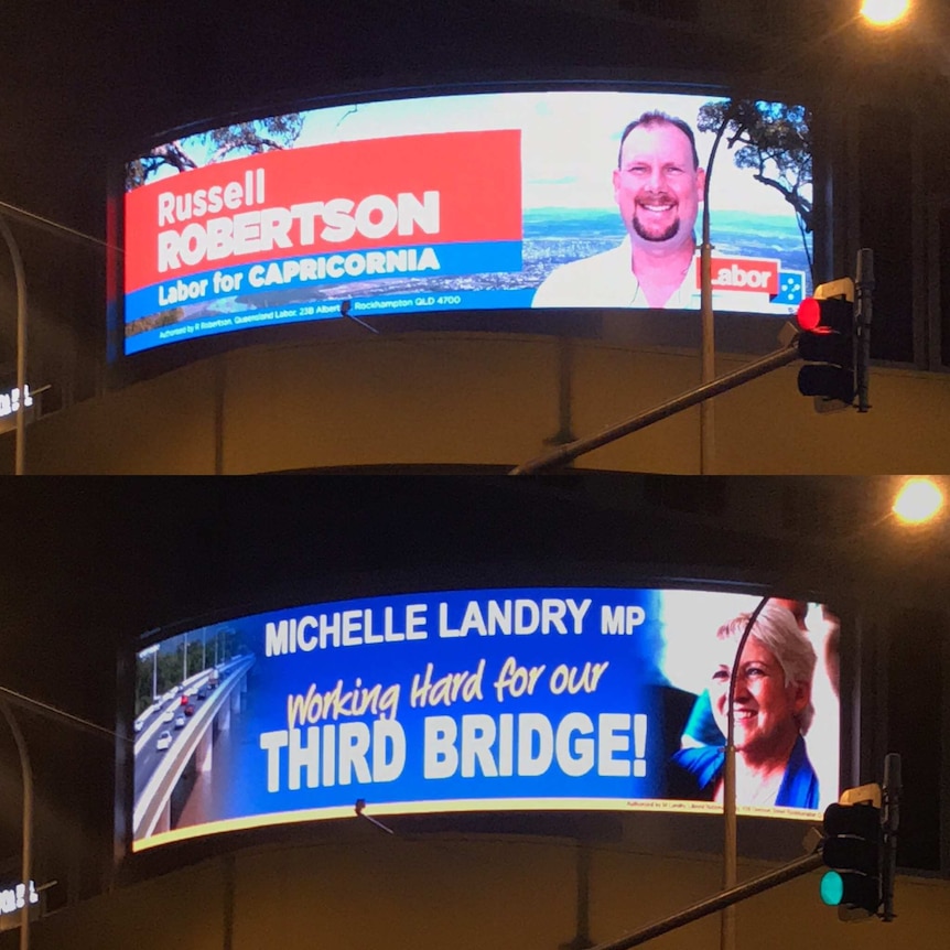 a billboard with two faces on it